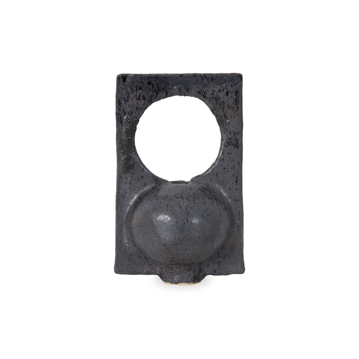 Featuring a round body with a circular negative space, The Santi Vessel is hand-sculpted and finished with a black glaze with textured carbon molting.