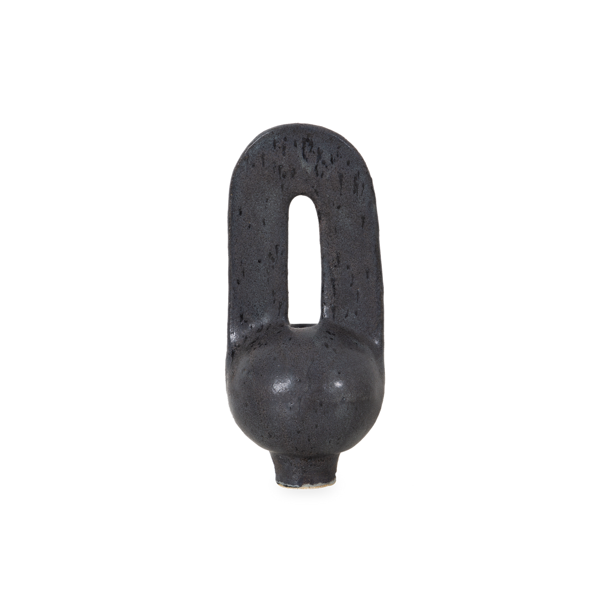 Characterized by its organic curves and sculptural arc silhouette, the Arcade Vessel is hand-sculpted and finished with a black glaze with textured carbon molting.
